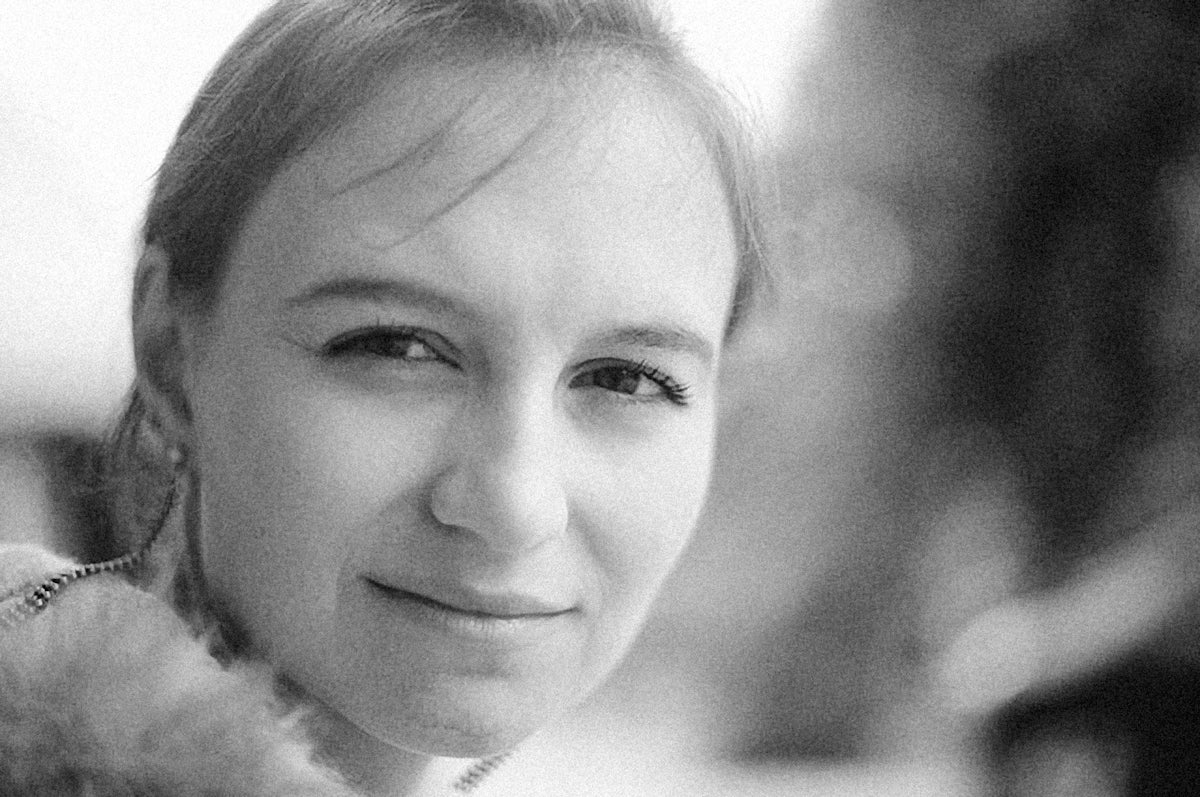 a black and white photo of a girl smiling