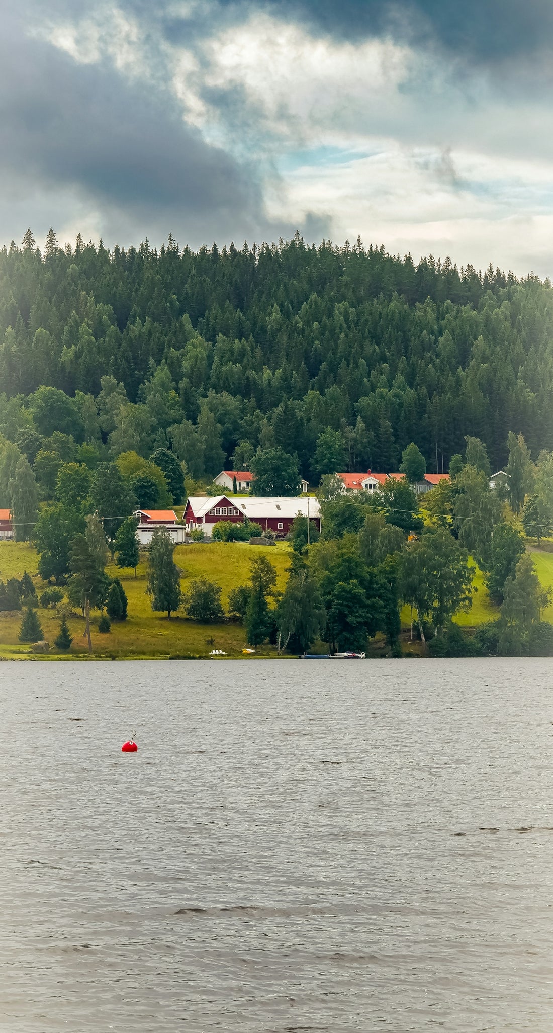 A small boat floating on top of a large body of water