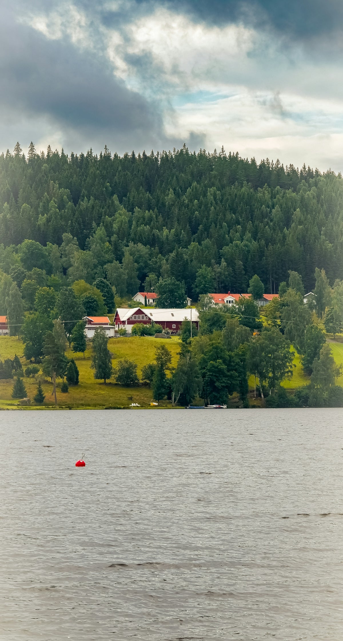 A small boat floating on top of a large body of water