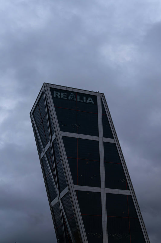 The tilting realia building against a cloudy sky.