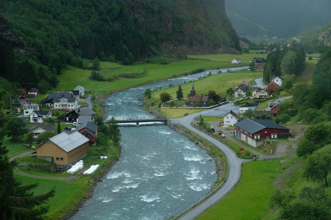 A winding river flows through a quaint valley.