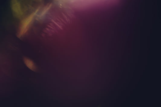 Abstract dark background with purple and yellow light flares